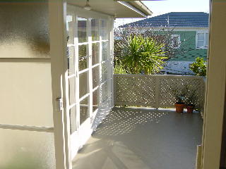 het deck, een stuk kleiner dan het vorige huis, maar groot genoeg voor ontbijt in de zon